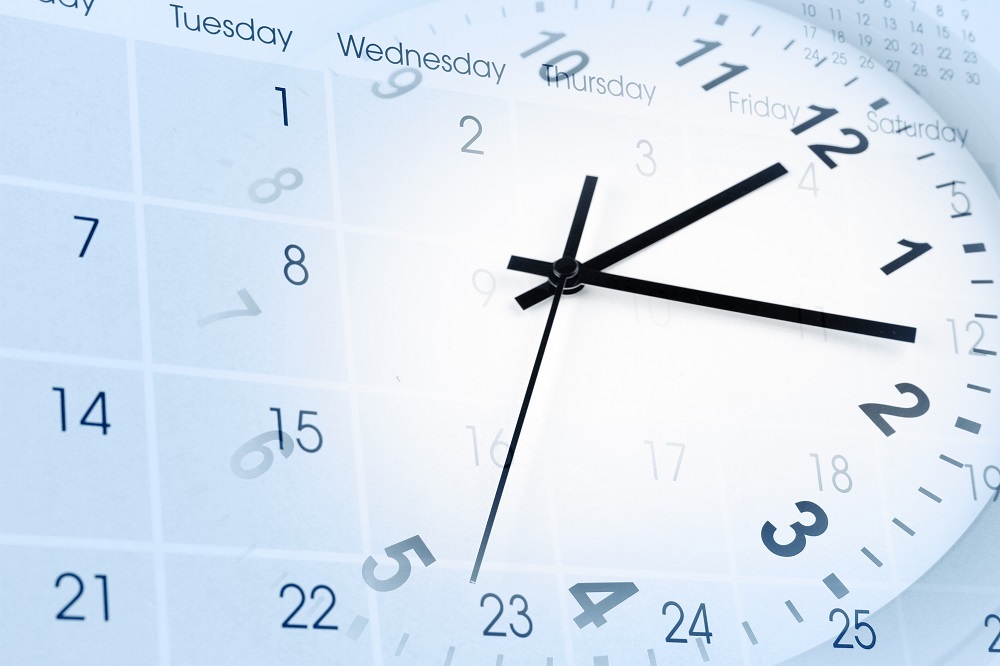 face of clock and calendar page